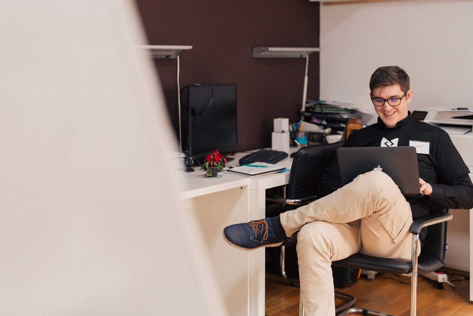 College student using a laptop exploring small business ideas at home