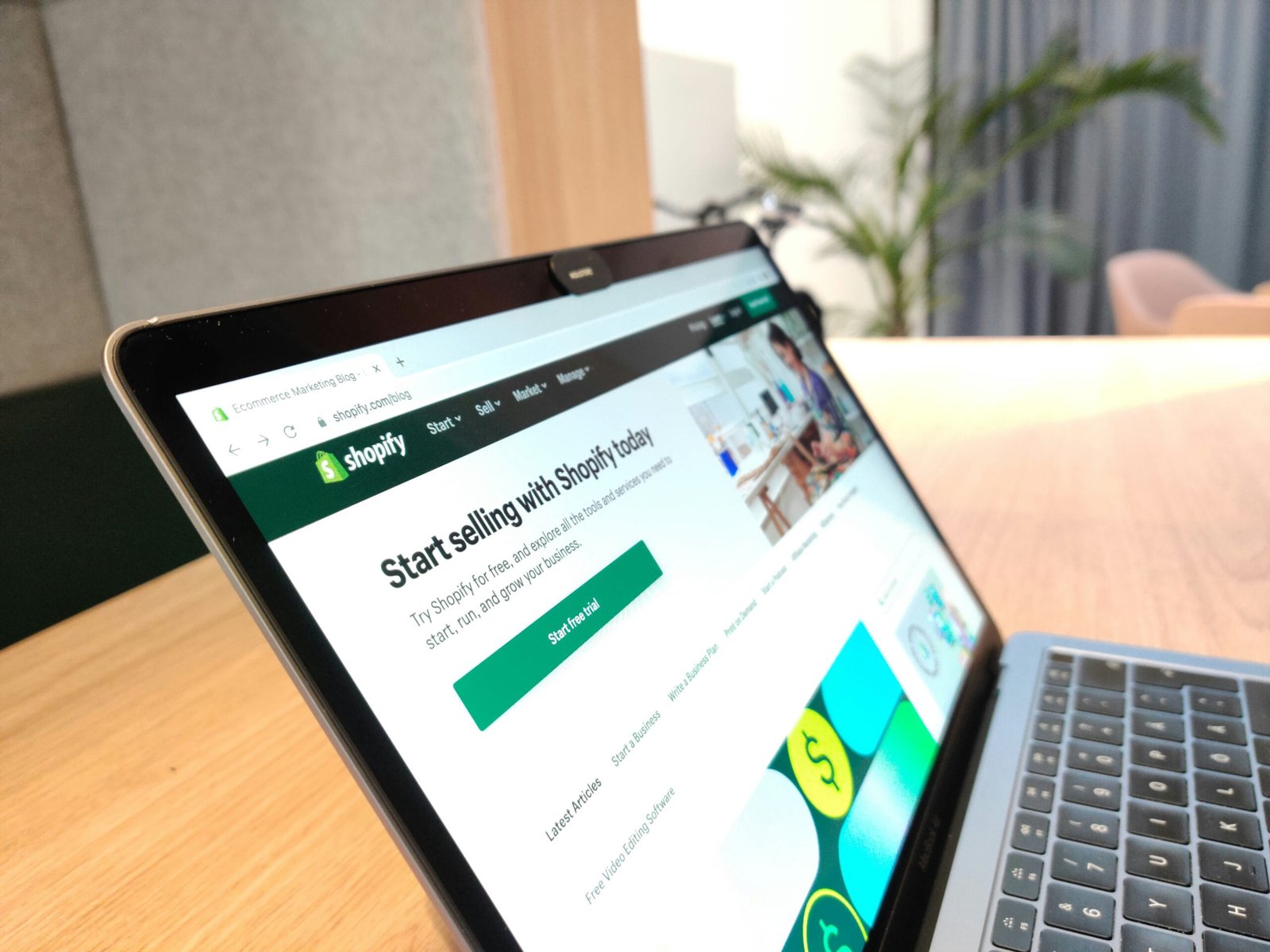 Setting Up Shopify on laptop showing Shopify website homepage